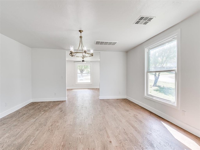 801 N Ash St, Guthrie, OK 73044 - spare room with a chandelier, light wood-type flooring, and baseboards