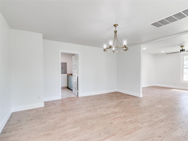801 N Ash St, Guthrie, OK 73044 - unfurnished room featuring a chandelier, light wood-style flooring, and baseboards