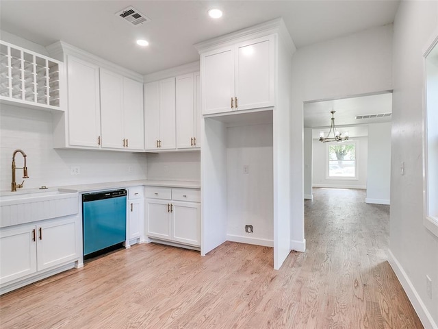 801 N Ash St, Guthrie, OK 73044 - kitchen with dishwasher, a sink, a chandelier, light wood-style flooring, and white cabinets