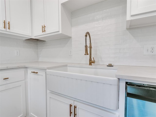 801 N Ash St, Guthrie, OK 73044 - kitchen with a sink, decorative backsplash, light countertops, and white cabinetry