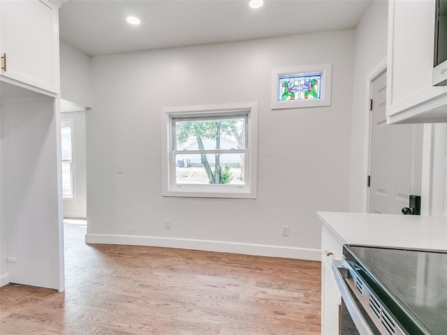 801 N Ash St, Guthrie, OK 73044 - kitchen featuring white cabinets, light wood finished floors, baseboards, and recessed lighting