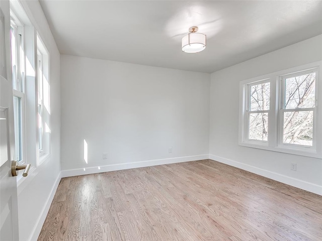 801 N Ash St, Guthrie, OK 73044 - unfurnished room with plenty of natural light, light wood-style flooring, and baseboards