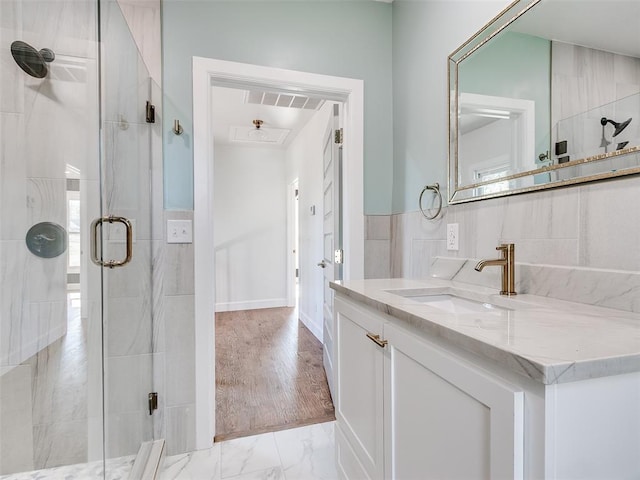 801 N Ash St, Guthrie, OK 73044 - full bath featuring vanity, a shower stall, and tile walls