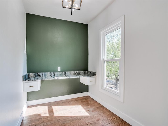 801 N Ash St, Guthrie, OK 73044 - laundry area with wood finished floors, baseboards, and a chandelier