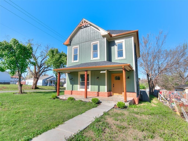 801 N Ash St, Guthrie, OK 73044 - view of front facade featuring a porch, brick siding, a front lawn, central air condition unit, and a shingled roof