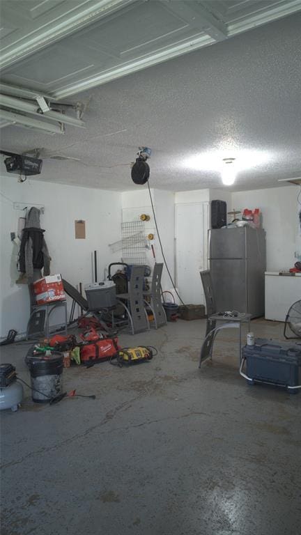 428 NW 91st St, Oklahoma City, OK 73114 - garage with freestanding refrigerator and a garage door opener