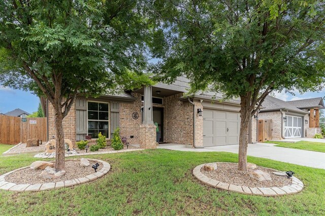 17912 Marron Dr, Edmond, OK 73012 - view of front facade with driveway, brick siding, and a garage