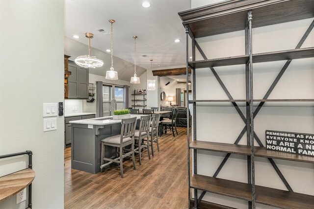 17912 Marron Dr, Edmond, OK 73012 - kitchen featuring light countertops, gray cabinets, a breakfast bar, recessed lighting, and a center island with sink
