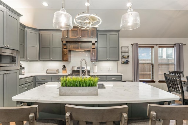 17912 Marron Dr, Edmond, OK 73012 - kitchen featuring gray cabinetry, stainless steel appliances, hanging light fixtures, backsplash, and recessed lighting