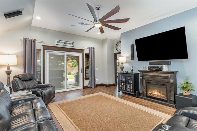 17912 Marron Dr, Edmond, OK 73012 - living room featuring wood finished floors, ceiling fan, a glass covered fireplace, and recessed lighting