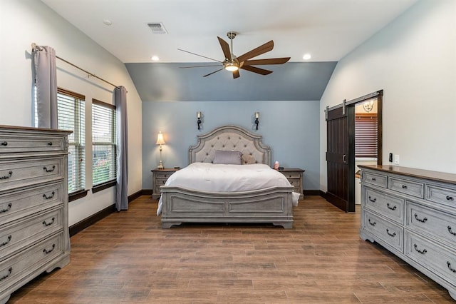 17912 Marron Dr, Edmond, OK 73012 - bedroom featuring vaulted ceiling, a barn door, baseboards, dark wood-style floors, and ceiling fan