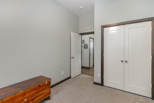 17912 Marron Dr, Edmond, OK 73012 - unfurnished bedroom featuring light carpet, baseboards, and a closet