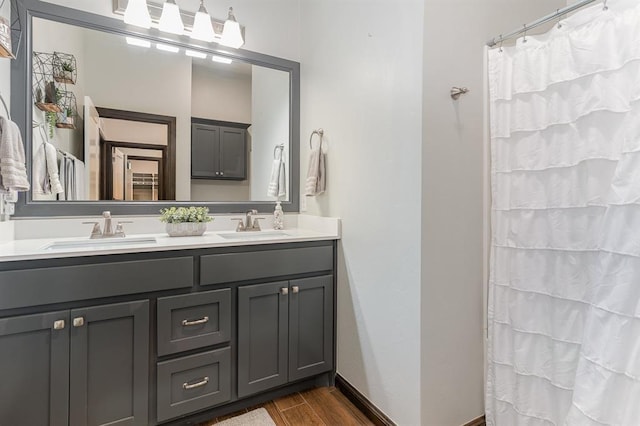 17912 Marron Dr, Edmond, OK 73012 - full bath with double vanity, wood finished floors, and a shower with shower curtain