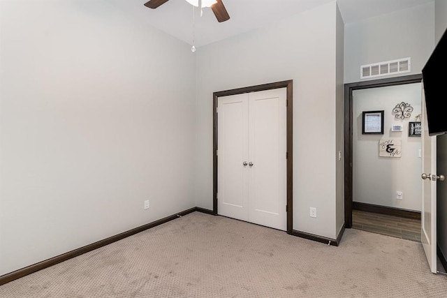 17912 Marron Dr, Edmond, OK 73012 - unfurnished bedroom featuring light colored carpet, baseboards, ceiling fan, and a closet