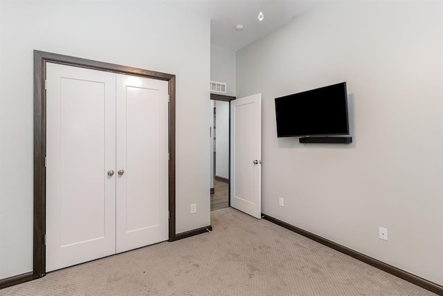 17912 Marron Dr, Edmond, OK 73012 - unfurnished bedroom with light carpet, baseboards, and a closet
