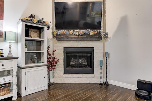 3366 Antler Vly, Guthrie, OK 73044 - living room featuring dark wood-type flooring, baseboards, and a stone fireplace