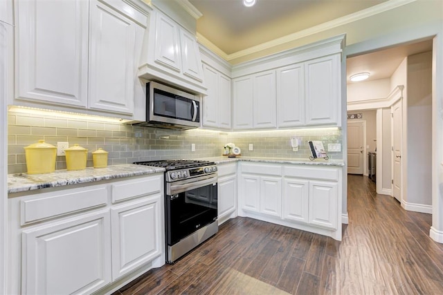 3366 Antler Vly, Guthrie, OK 73044 - kitchen featuring appliances with stainless steel finishes, backsplash, white cabinetry, dark wood-type flooring, and crown molding