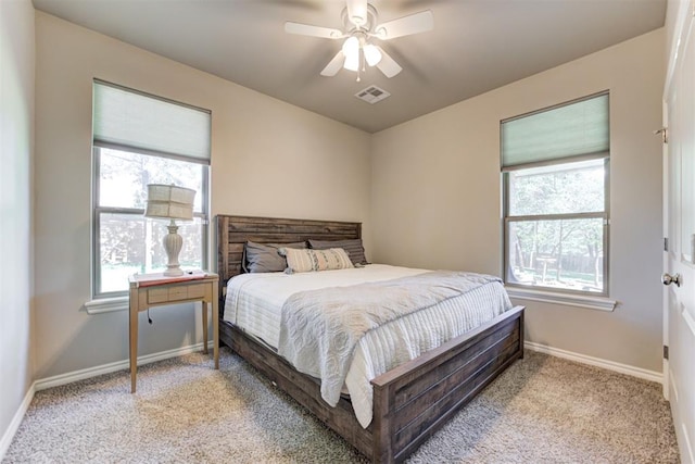 3366 Antler Vly, Guthrie, OK 73044 - carpeted bedroom with multiple windows, baseboards, and ceiling fan