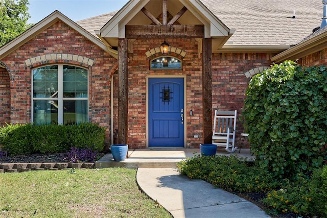 3366 Antler Vly, Guthrie, OK 73044 - doorway to property featuring brick siding, roof with shingles, and a yard