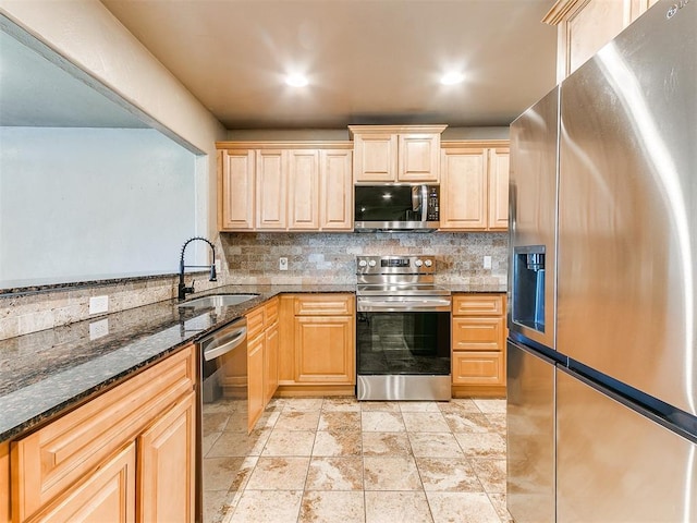 613 S Avery St, Moore, OK 73160 - kitchen featuring stainless steel appliances, a sink, tasteful backsplash, light brown cabinets, and dark stone counters