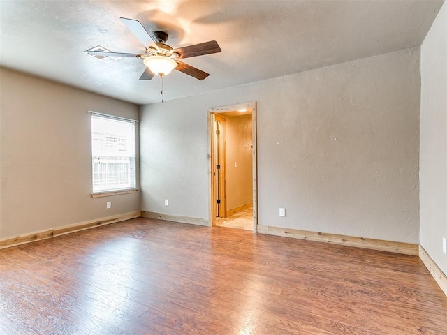 613 S Avery St, Moore, OK 73160 - unfurnished room with wood finished floors, ceiling fan, and baseboards