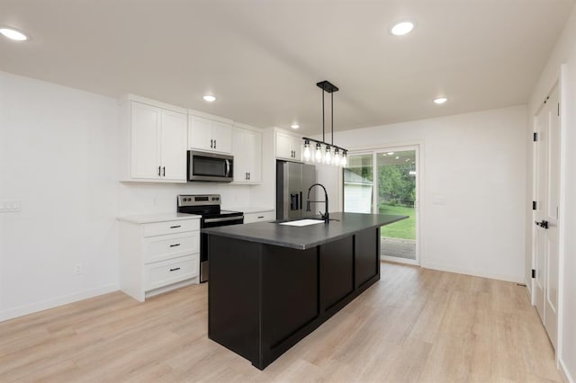 1828 NW 38th St, Oklahoma City, OK 73118 - kitchen featuring stainless steel appliances, light wood finished floors, recessed lighting, white cabinets, and baseboards