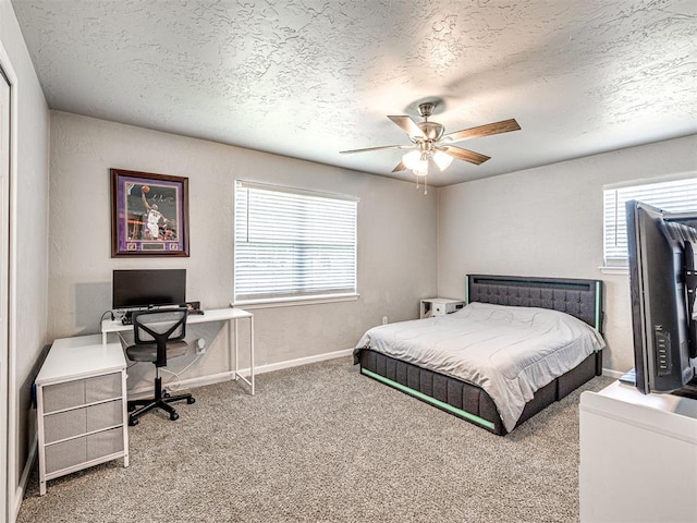 621 W 2nd St, Calumet, OK 73014 - bedroom with a textured ceiling, carpet flooring, a desk, ceiling fan, and baseboards