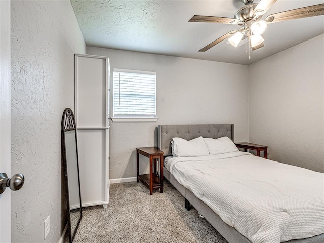 621 W 2nd St, Calumet, OK 73014 - bedroom with a textured wall, light carpet, baseboards, and ceiling fan