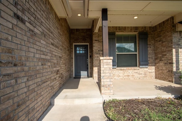 12916 Ponderosa Blvd, Oklahoma City, OK 73142 - doorway to property with brick siding and covered porch