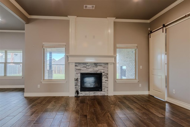 12916 Ponderosa Blvd, Oklahoma City, OK 73142 - unfurnished living room featuring dark wood-type flooring, ornamental molding, a barn door, a stone fireplace, and baseboards