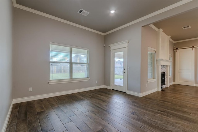 12916 Ponderosa Blvd, Oklahoma City, OK 73142 - unfurnished living room with dark wood-style flooring, crown molding, baseboards, and a barn door
