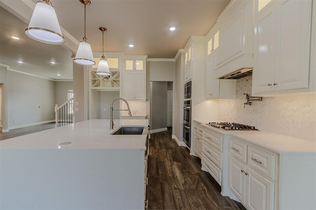 12916 Ponderosa Blvd, Oklahoma City, OK 73142 - kitchen with a sink, ornamental molding, dark wood-style flooring, glass insert cabinets, and tasteful backsplash