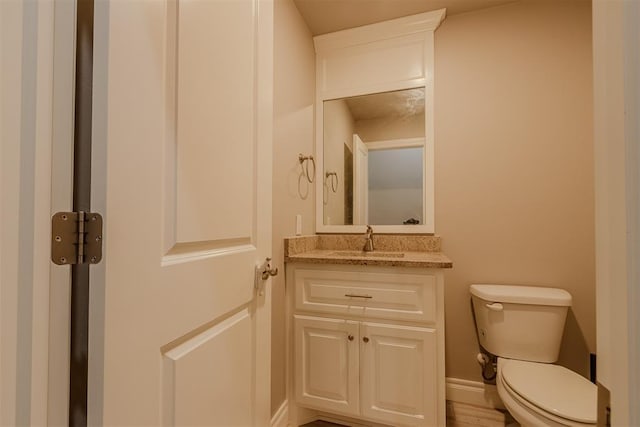 12916 Ponderosa Blvd, Oklahoma City, OK 73142 - bathroom featuring toilet, vanity, and baseboards