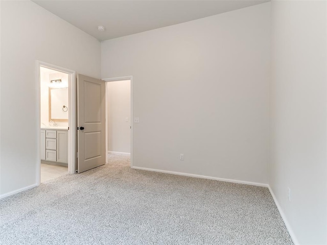 14613 Brantwood Cir, Oklahoma City, OK 73142 - spare room with light colored carpet, baseboards, a smoke detector, and a sink