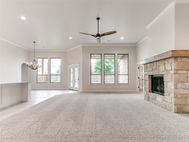 14613 Brantwood Cir, Oklahoma City, OK 73142 - unfurnished living room with recessed lighting, a chandelier, a stone fireplace, ceiling fan, and crown molding