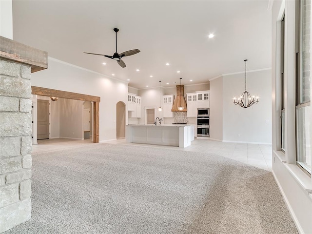 14613 Brantwood Cir, Oklahoma City, OK 73142 - unfurnished living room featuring light carpet, ceiling fan, a sink, a chandelier, and ornamental molding