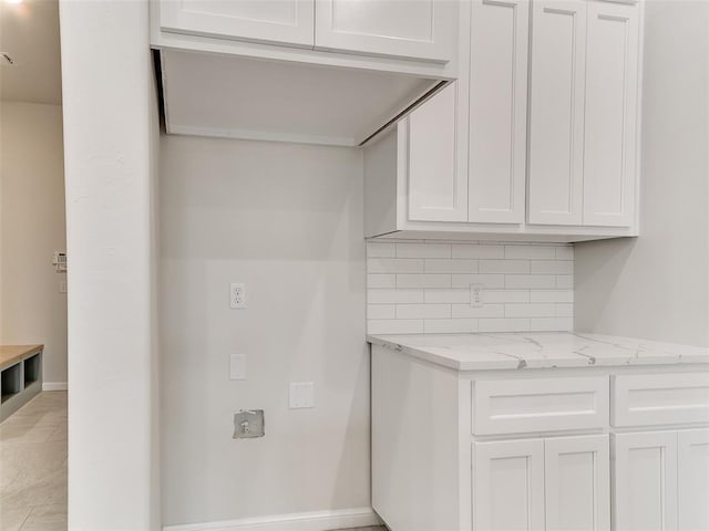 14613 Brantwood Cir, Oklahoma City, OK 73142 - kitchen with light stone counters, backsplash, and white cabinets