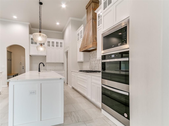 14613 Brantwood Cir, Oklahoma City, OK 73142 - kitchen featuring appliances with stainless steel finishes, ornamental molding, tasteful backsplash, a sink, and light stone counters