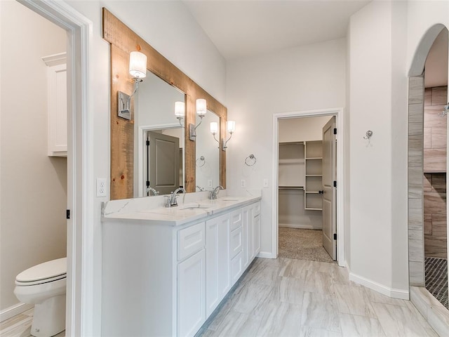 14613 Brantwood Cir, Oklahoma City, OK 73142 - bathroom featuring double vanity, toilet, and baseboards