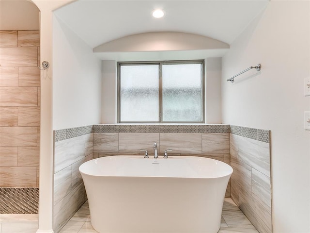 14613 Brantwood Cir, Oklahoma City, OK 73142 - bathroom with tile walls, a freestanding bath, wainscoting, recessed lighting, and a tile shower