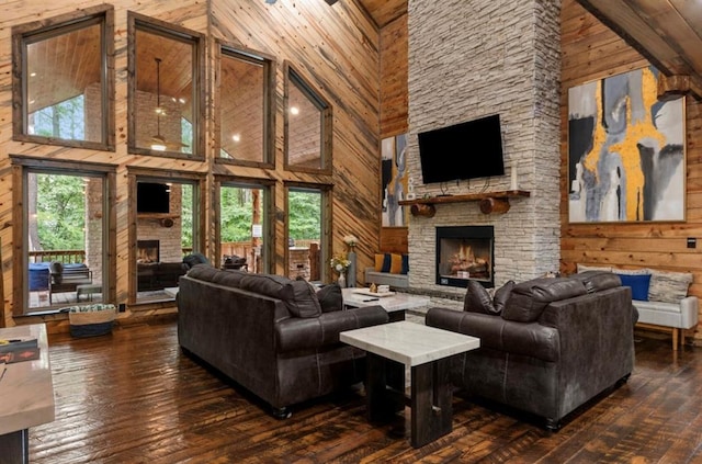 31 Conifer Crossing Trl, Broken Bow, OK 74728 - living room with a fireplace, high vaulted ceiling, wood walls, and dark wood-style flooring