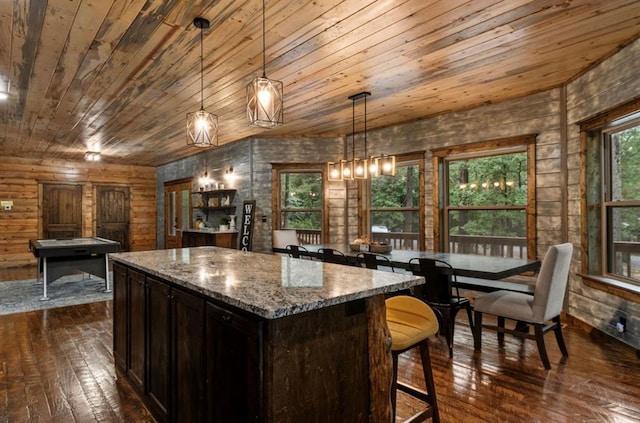 31 Conifer Crossing Trl, Broken Bow, OK 74728 - kitchen with wood ceiling, dark wood-style flooring, a center island, light stone counters, and hanging light fixtures