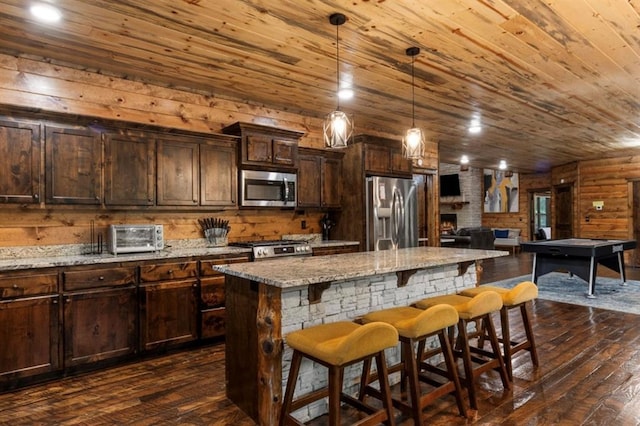 31 Conifer Crossing Trl, Broken Bow, OK 74728 - kitchen with appliances with stainless steel finishes, wood ceiling, dark wood-type flooring, a kitchen bar, and a kitchen island