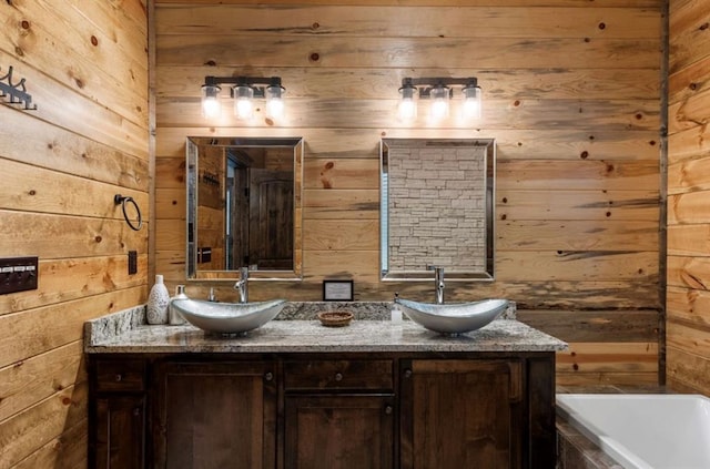 31 Conifer Crossing Trl, Broken Bow, OK 74728 - bathroom with wooden walls, double vanity, and a relaxing tiled tub