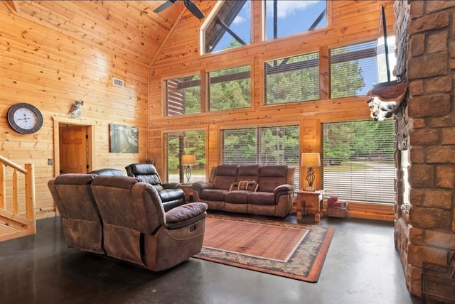 170 Driftcast Rd, Broken Bow, OK 74728 - living room with high vaulted ceiling, ceiling fan, wood walls, and concrete flooring