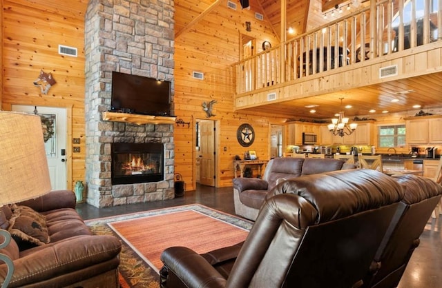 170 Driftcast Rd, Broken Bow, OK 74728 - living room with wooden walls, high vaulted ceiling, a fireplace, a chandelier, and wood finished floors