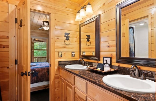 170 Driftcast Rd, Broken Bow, OK 74728 - ensuite bathroom featuring double vanity, wood walls, and ceiling fan