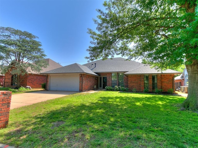 16716 Valley Crst, Edmond, OK 73012 - view of front facade with a garage, concrete driveway, brick siding, and a front lawn