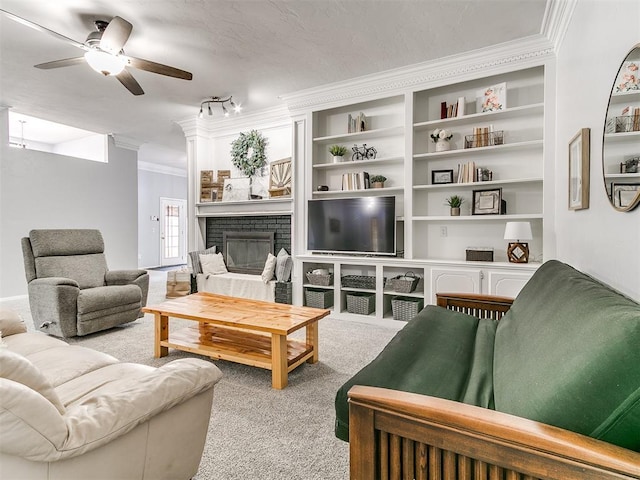 16716 Valley Crst, Edmond, OK 73012 - living area featuring carpet flooring, a brick fireplace, crown molding, a ceiling fan, and track lighting