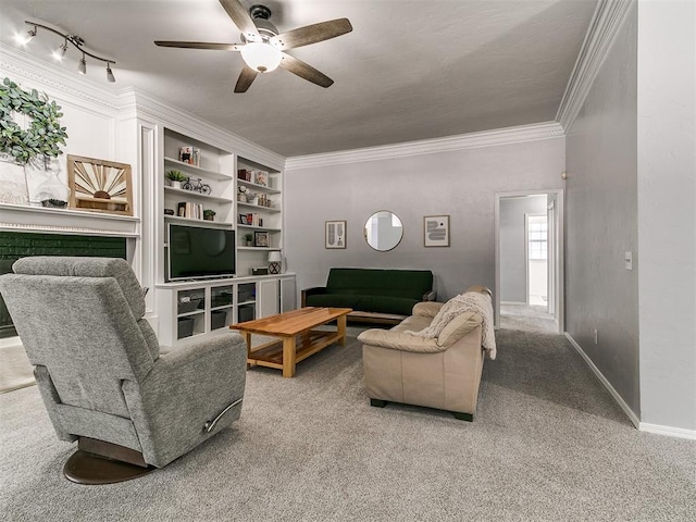 16716 Valley Crst, Edmond, OK 73012 - living area with crown molding, carpet flooring, a ceiling fan, baseboards, and built in shelves
